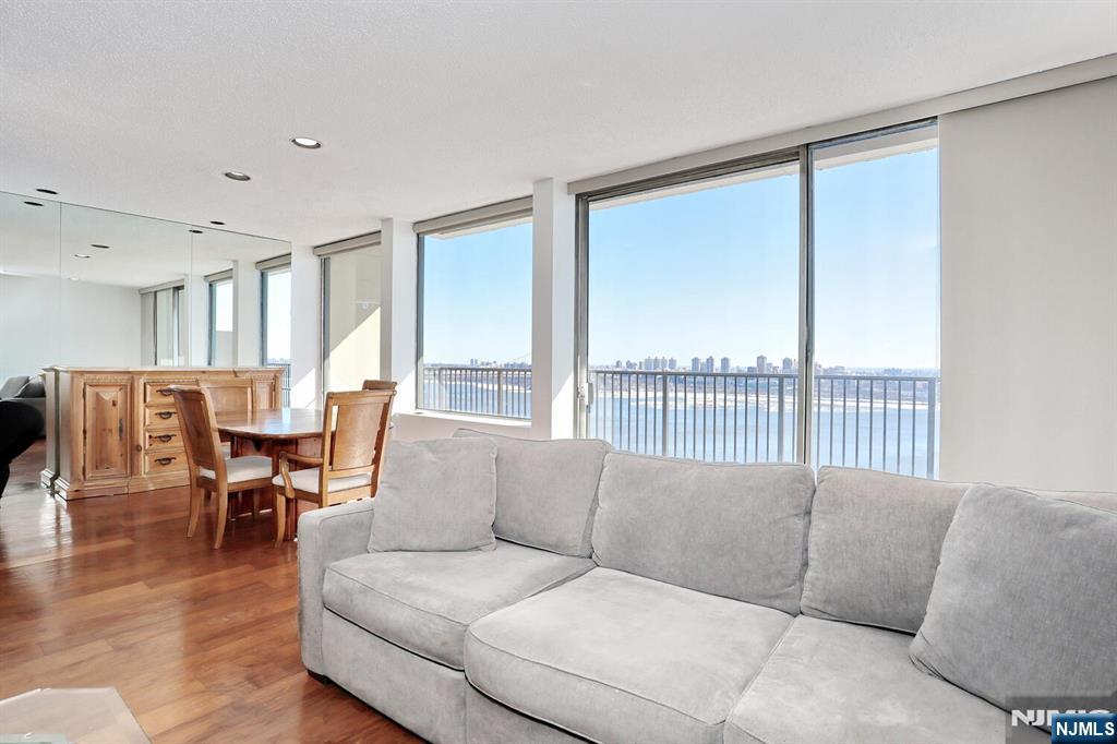 3 Horizon Road, Unit 1432 Fort Lee, NJ 07024 - Photo 9 of 49 a living room with furniture and a large window