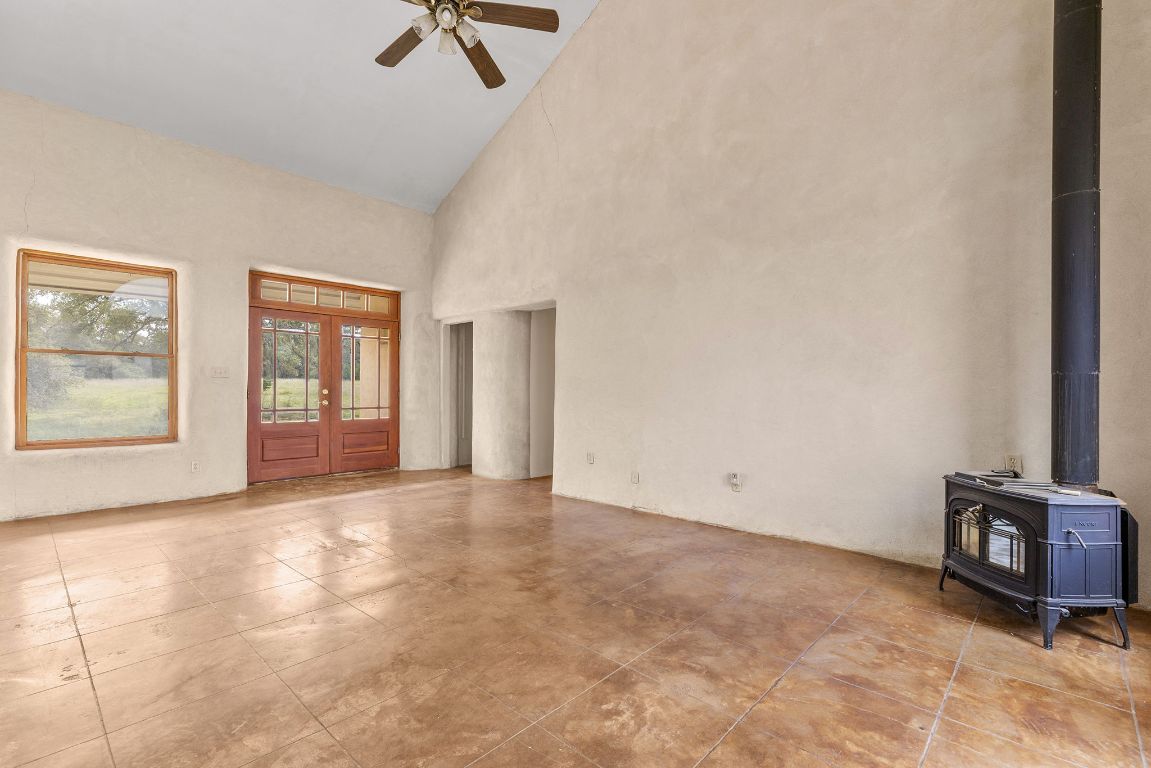 1400 Cobb Creek Road Georgetown, TX 78633 - Photo 7 of 38 an empty room with windows and ceiling fan