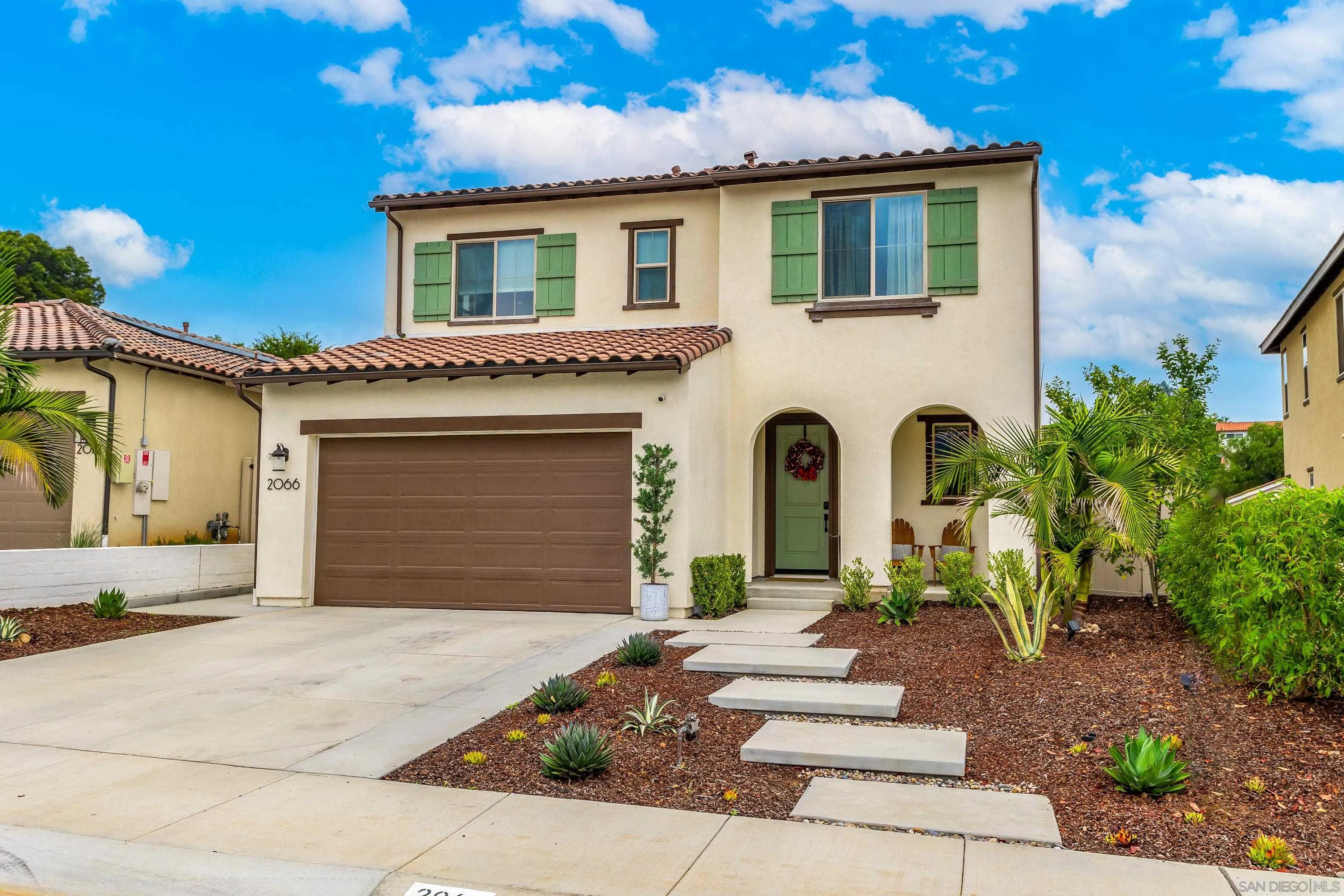 a front view of a house with garden