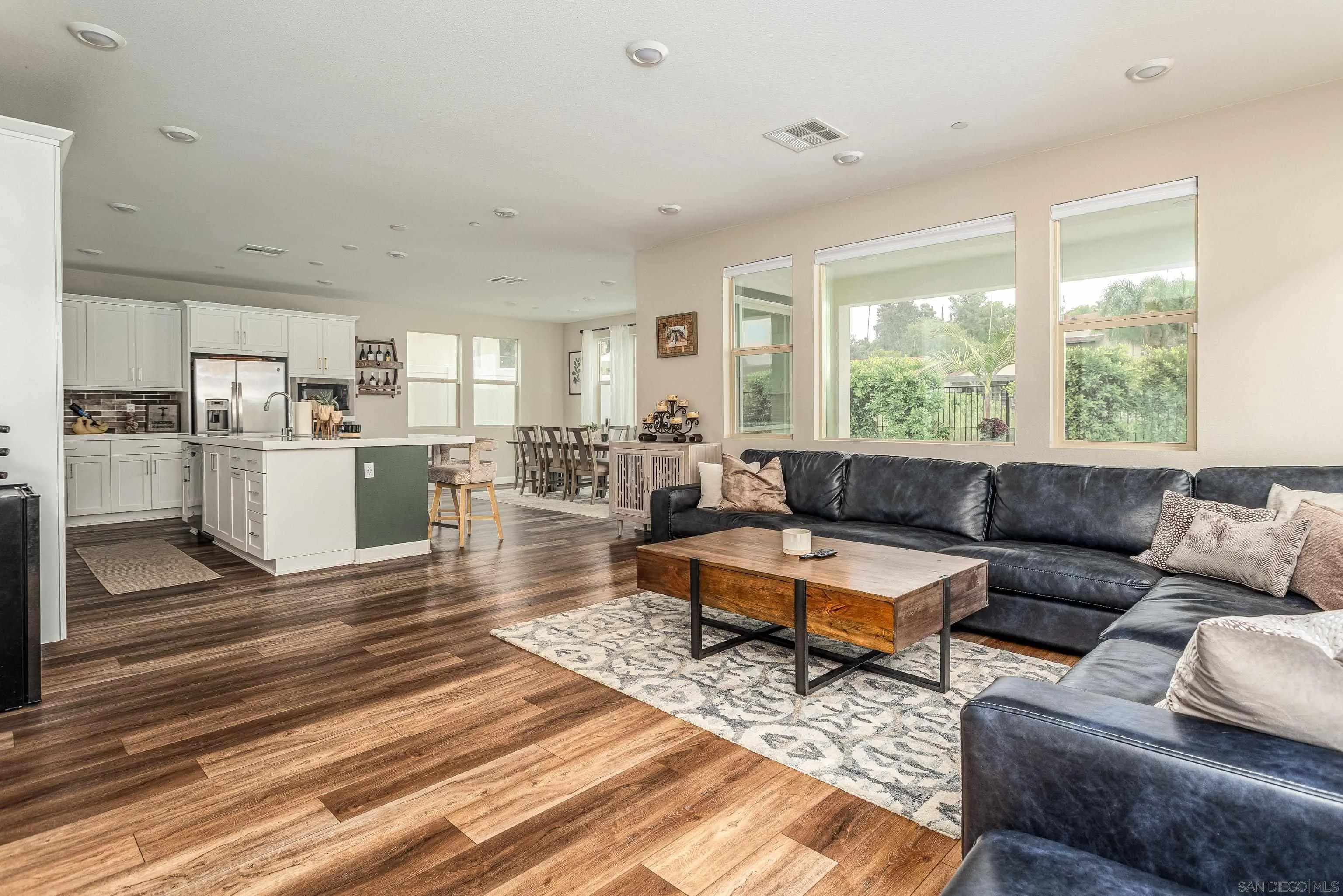 2066 Bruno Place Escondido, CA 92026 - Photo 12 of 33 a living room with lots of furniture wooden floor and a large window
