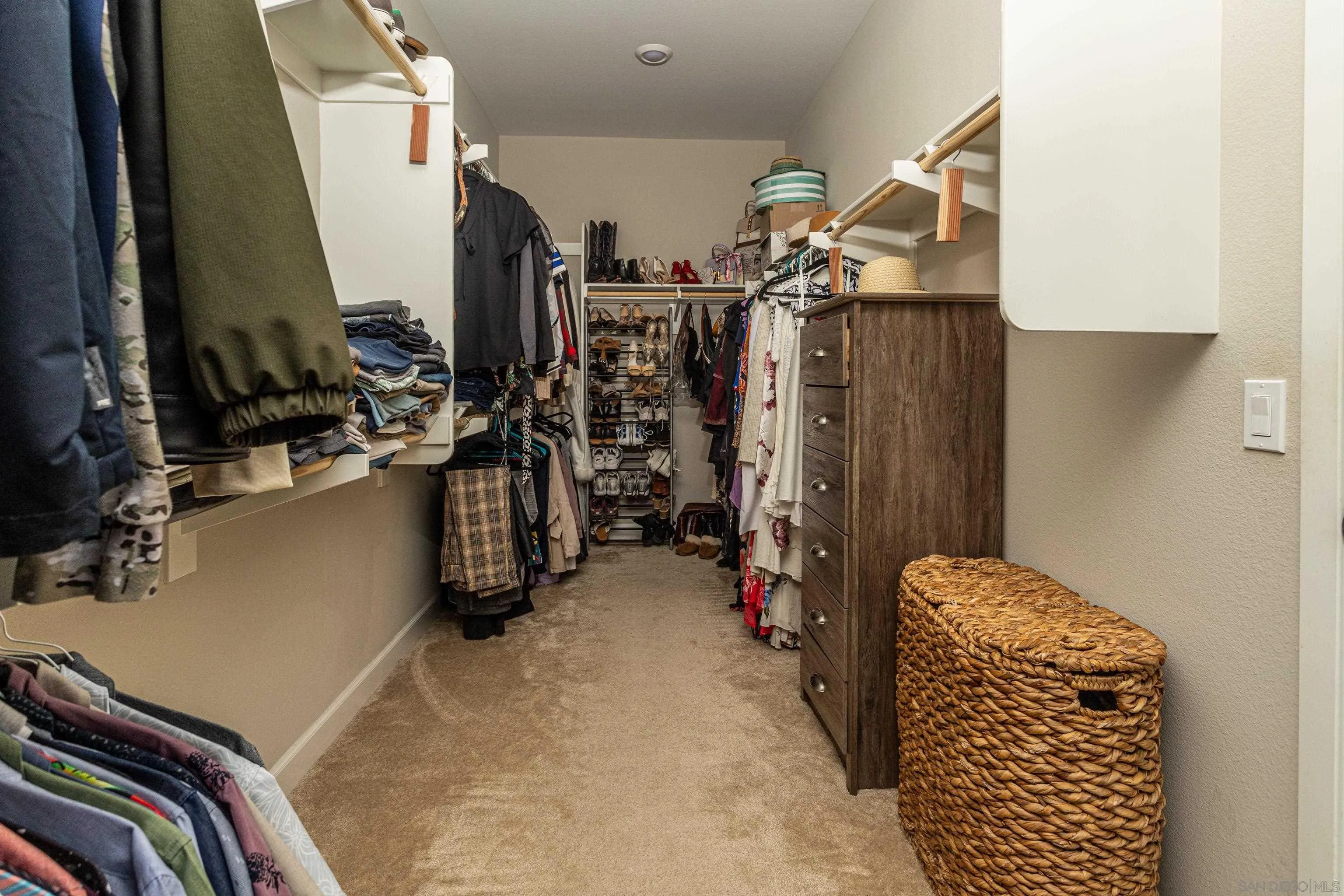 2066 Bruno Place Escondido, CA 92026 - Photo 23 of 33 a view of walk in closet with clothes and shoes