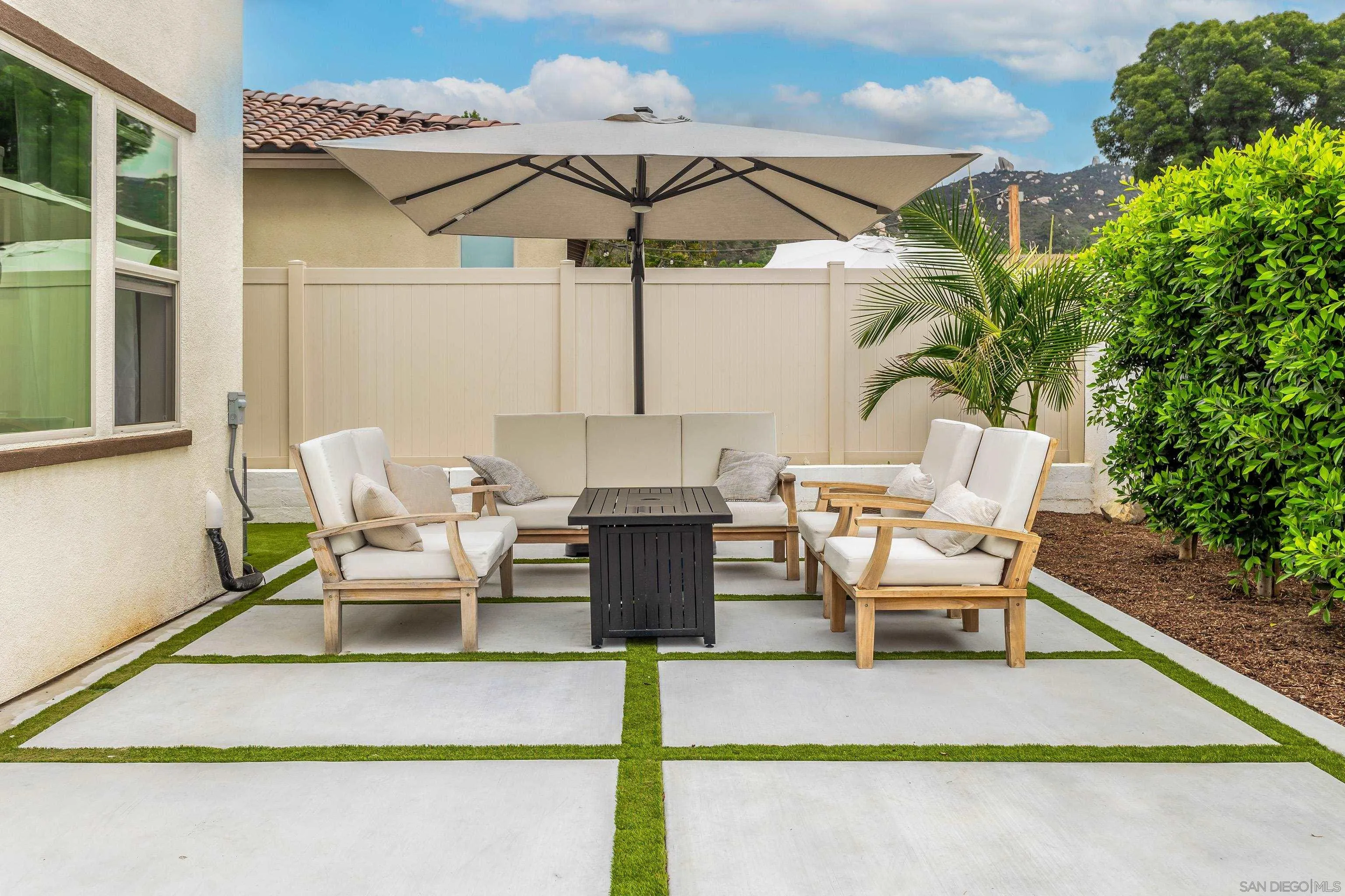 2066 Bruno Place Escondido, CA 92026 - Photo 27 of 33 a view of a patio with a table and chairs under an umbrella