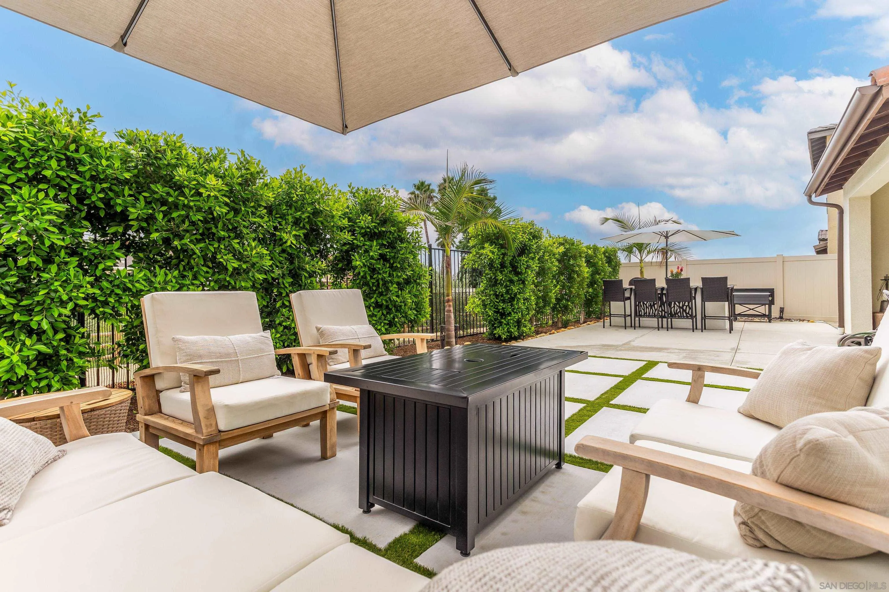 2066 Bruno Place Escondido, CA 92026 - Photo 28 of 33 a view of a patio with couches table and chairs under an umbrella
