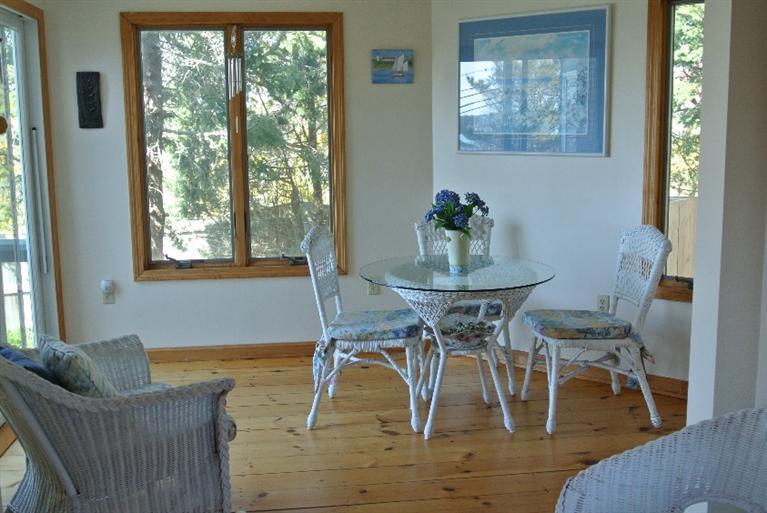 155 Stage Harbor Road Chatham, MA 02633 - Photo 9 of 11 a view of a dining room with furniture window and wooden floor