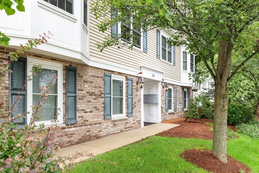 24 Wall Street, Unit E Canton, MA 02021 - Photo 1 of 19 front view of a house with a yard