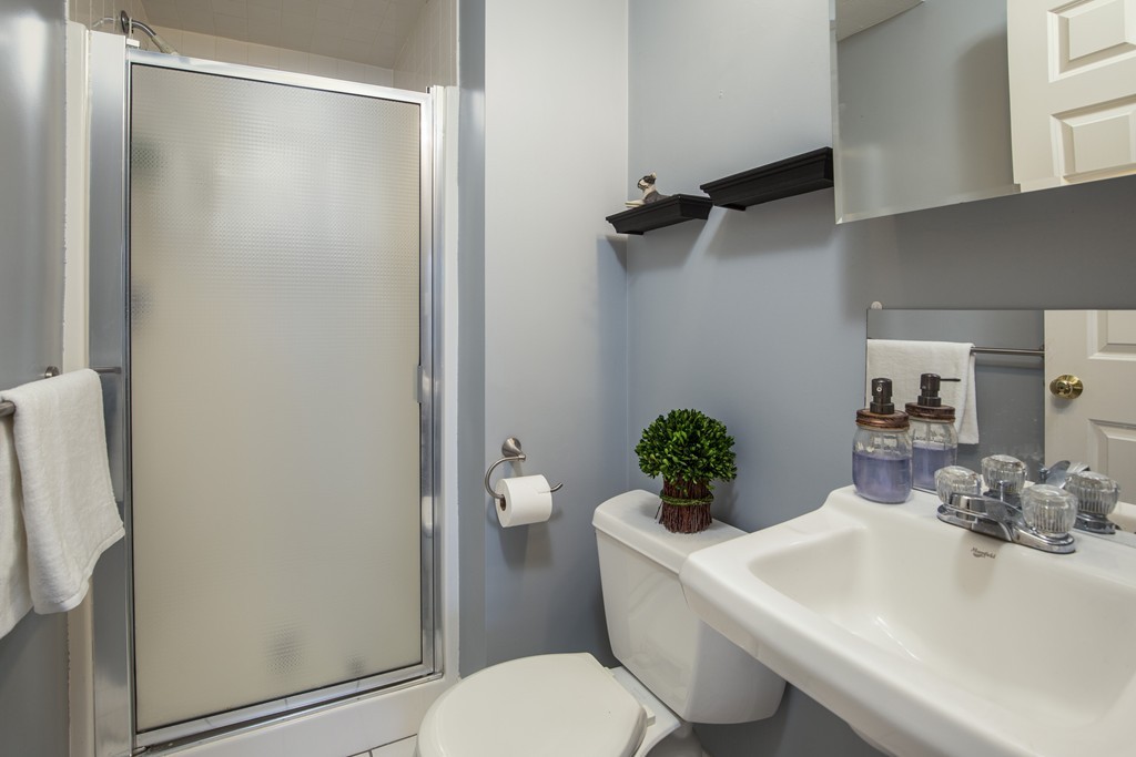 24 Wall Street, Unit E Canton, MA 02021 - Photo 14 of 19 a bathroom with a sink toilet and shower