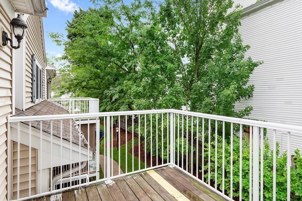 24 Wall Street, Unit E Canton, MA 02021 - Photo 16 of 19 a view of balcony with wooden floor and fence