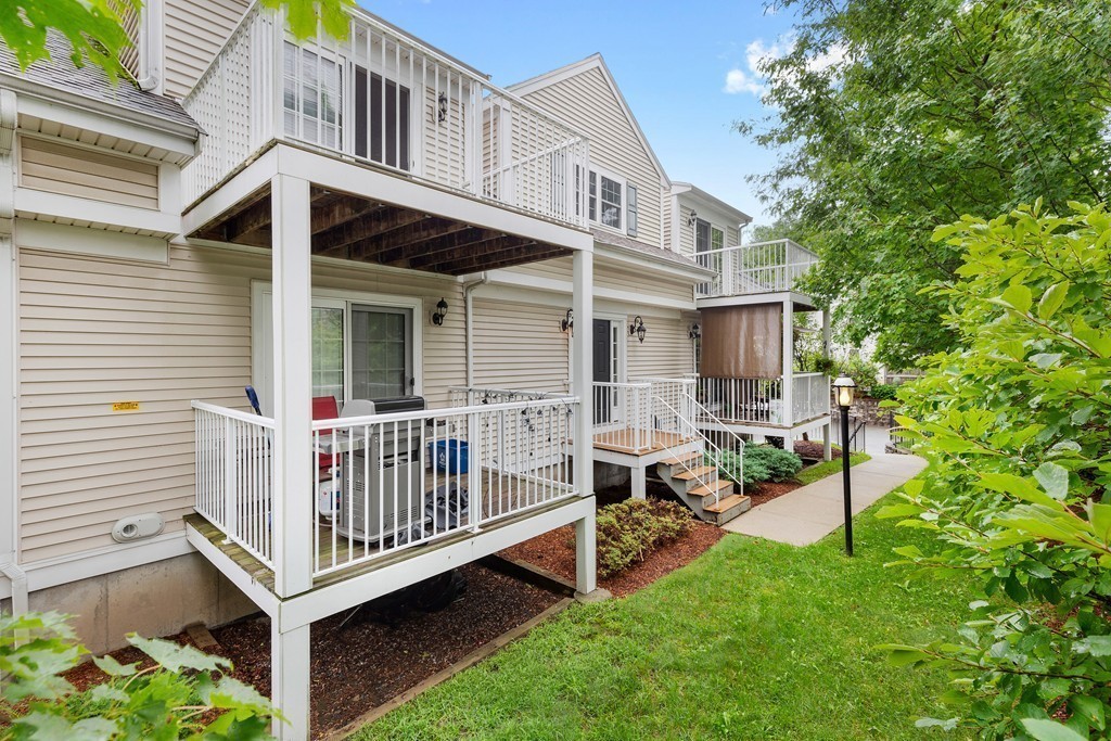 24 Wall Street, Unit E Canton, MA 02021 - Photo 17 of 19 a view of a house with a yard and sitting area