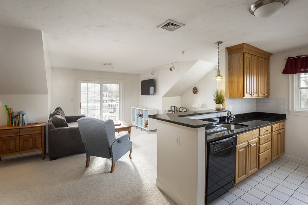 24 Wall Street, Unit E Canton, MA 02021 - Photo 3 of 19 a kitchen with stainless steel appliances granite countertop a stove and a sink