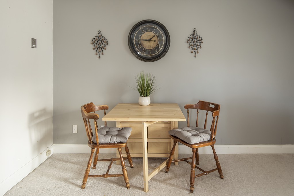 24 Wall Street, Unit E Canton, MA 02021 - Photo 6 of 19 a dining room with a table and a chair