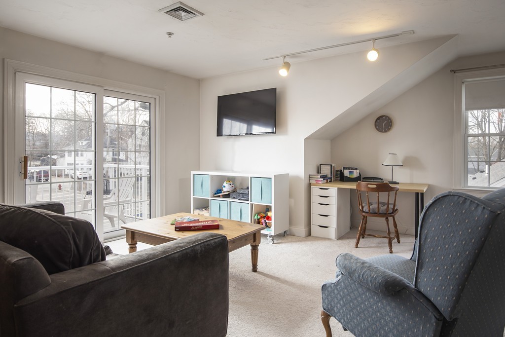 24 Wall Street, Unit E Canton, MA 02021 - Photo 7 of 19 a living room with furniture and a flat screen tv