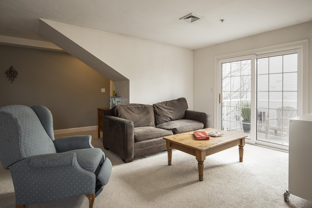 24 Wall Street, Unit E Canton, MA 02021 - Photo 8 of 19 a living room with furniture and a window