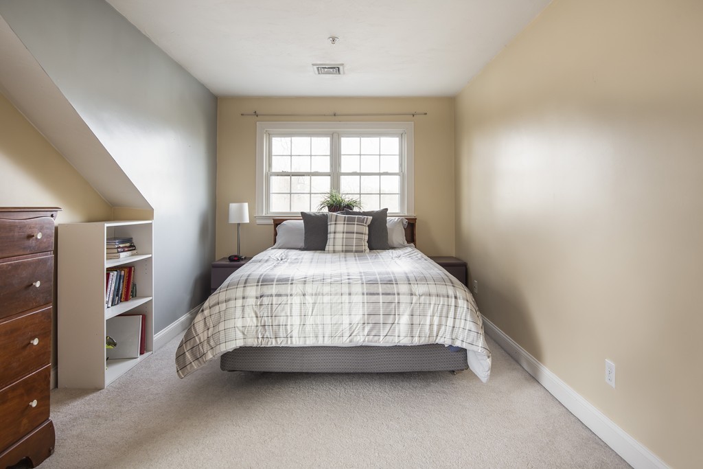 24 Wall Street, Unit E Canton, MA 02021 - Photo 10 of 19 a bedroom with a bed and a window