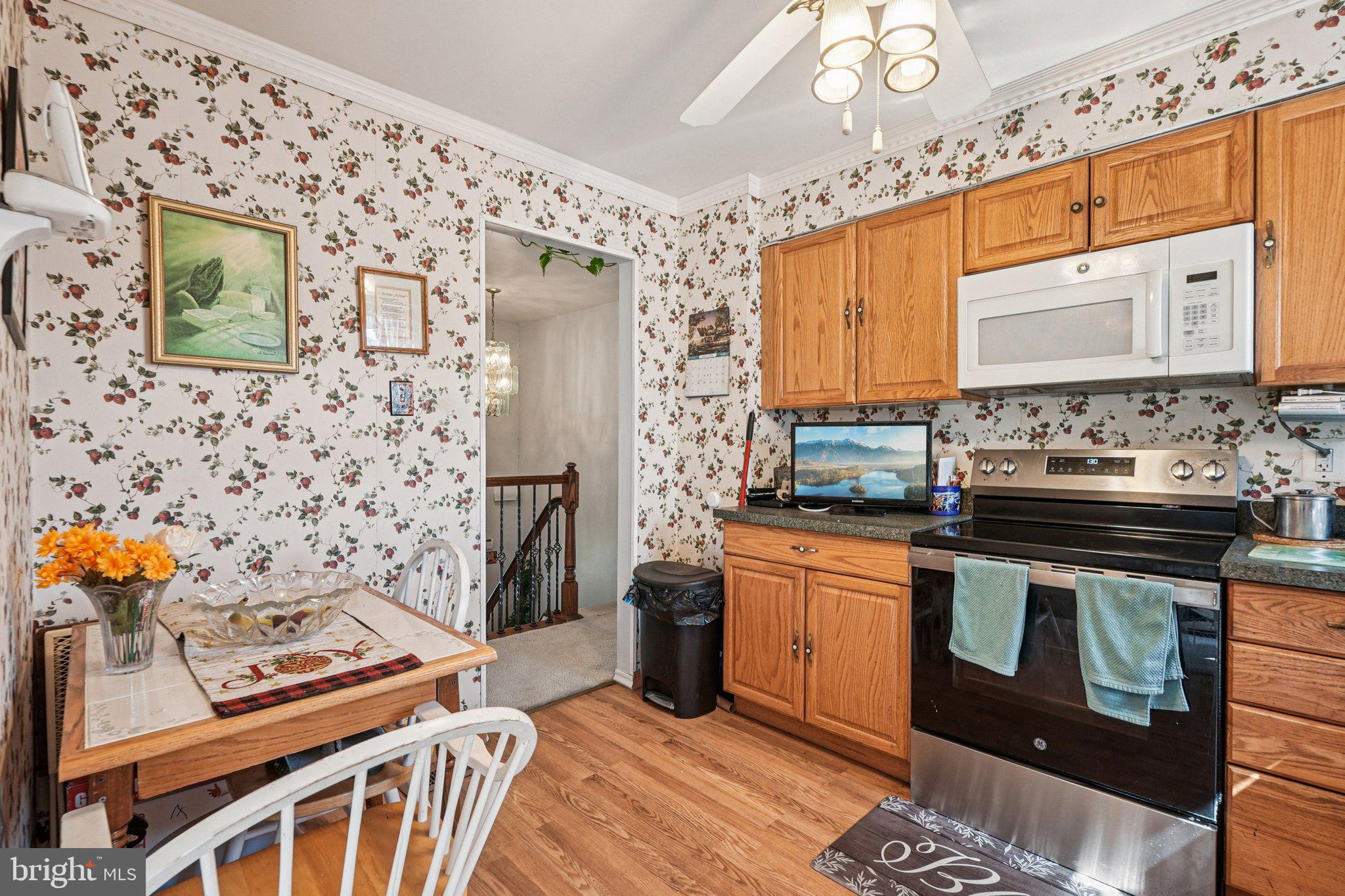 41 Harding Street Ewing, NJ 08618 - Photo 16 of 50 a kitchen with stainless steel appliances granite countertop a stove a sink and a refrigerator
