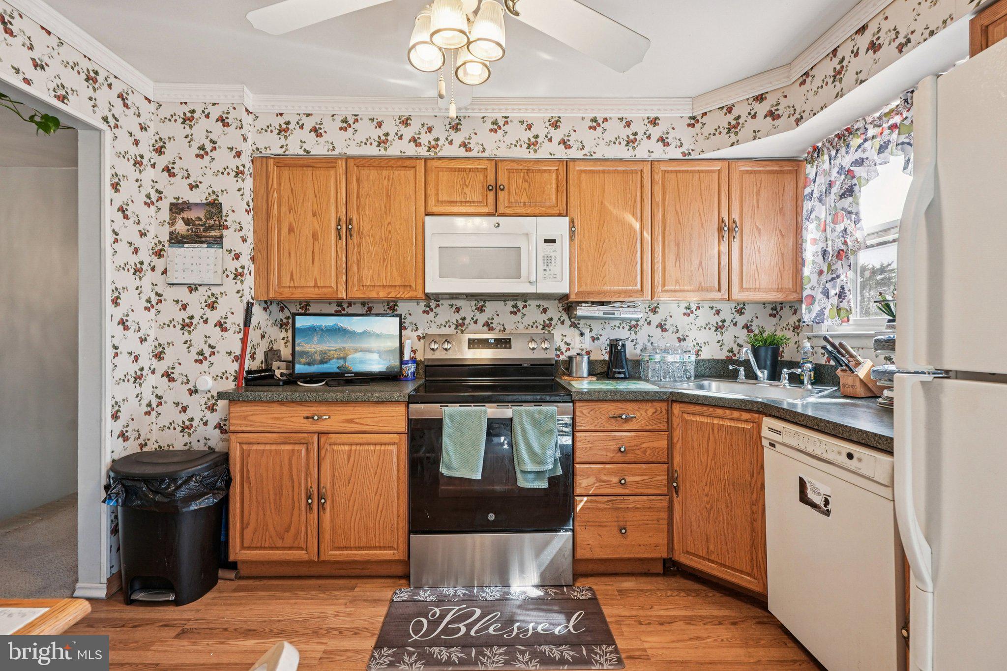 41 Harding Street Ewing, NJ 08618 - Photo 18 of 50 a kitchen with stainless steel appliances granite countertop a stove a sink and a microwave