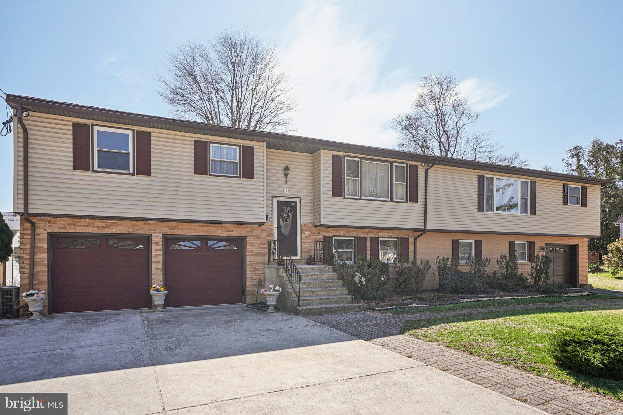41 Harding Street Ewing, NJ 08618 - Photo 2 of 50 a front view of a house with yard and parking
