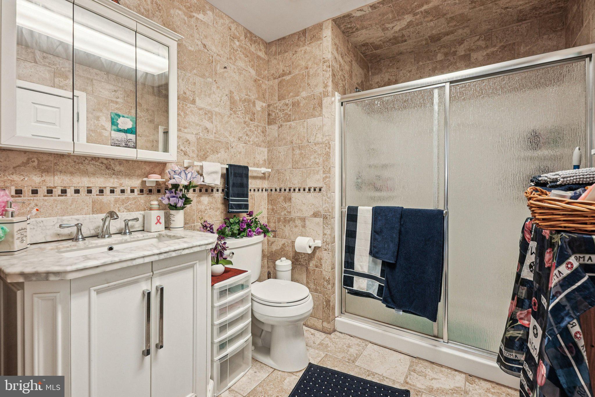 41 Harding Street Ewing, NJ 08618 - Photo 28 of 50 a bathroom with a sink toilet vanity and shower