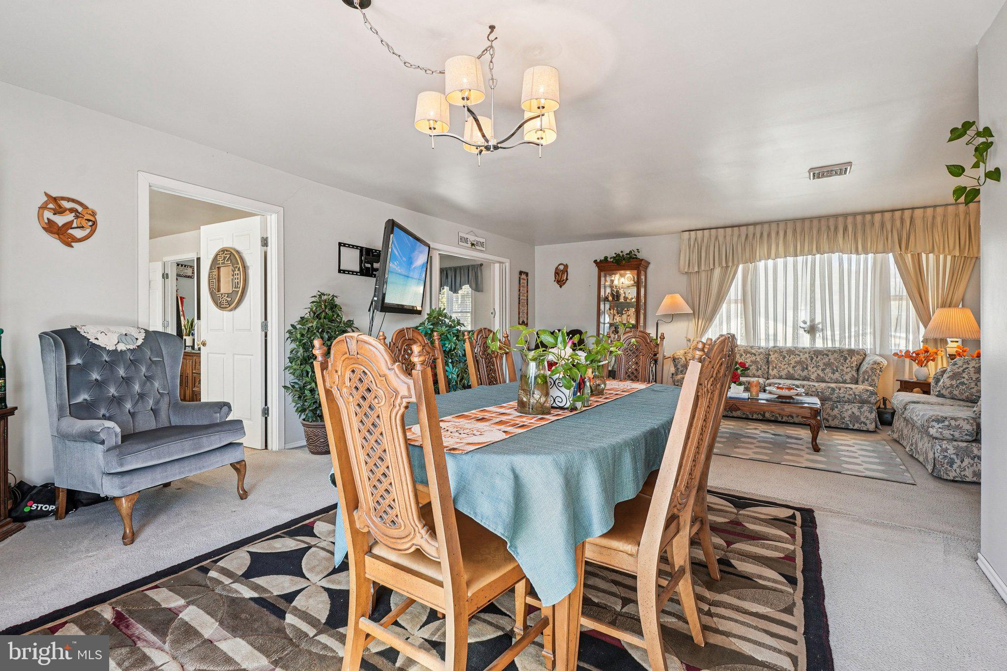 41 Harding Street Ewing, NJ 08618 - Photo 10 of 50 a dining room with furniture a rug and a chandelier