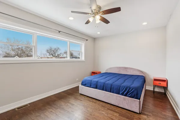 a living room with a bed furniture and a window