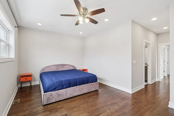 a room with a bed and a ceiling fan