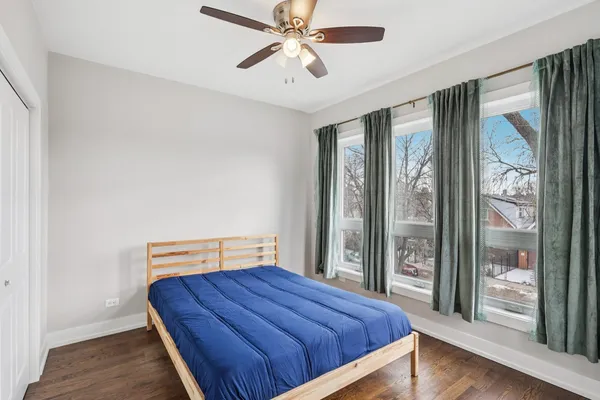 a bedroom with a bed and large window