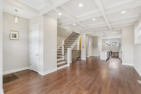 a view of empty room with wooden floor