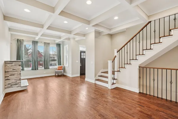 a view of an entryway with wooden floor