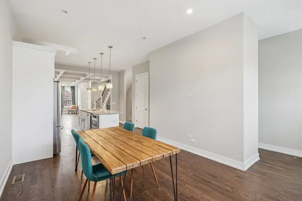 a view of a dining room with furniture and wooden floor