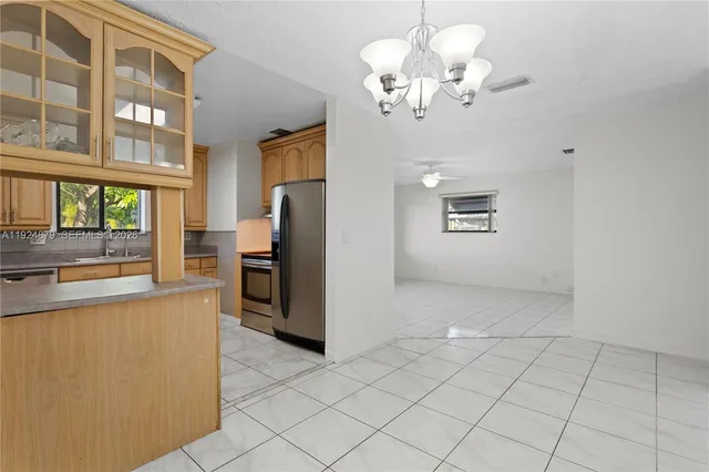 a kitchen with stainless steel appliances a stove a sink a microwave and cabinets