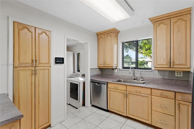 a kitchen with granite countertop a refrigerator stove and microwave