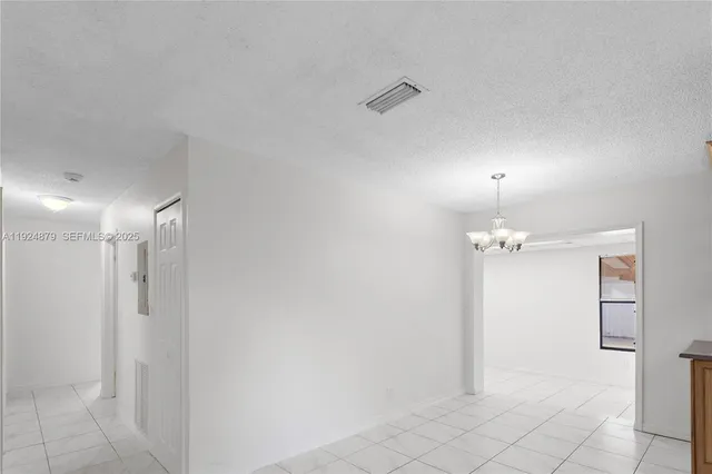 a view of a small space with wooden floor and windows