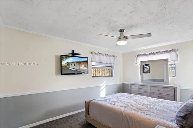 a spacious bedroom with a bed and a chandelier