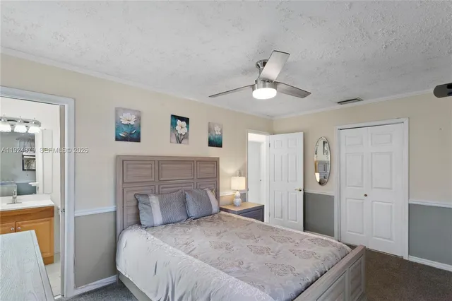 a bathroom with a sink vanity mirror and toilet