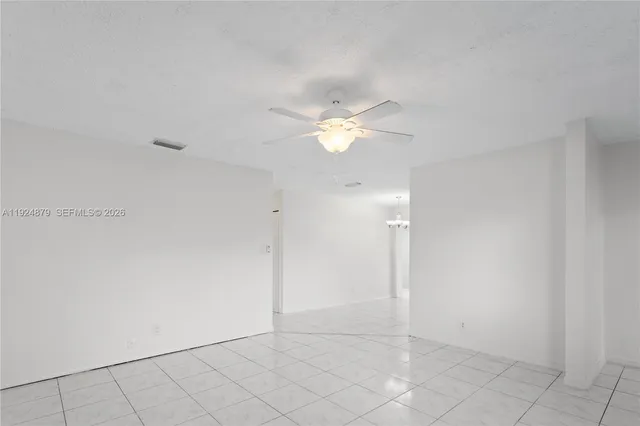 a view of a kitchen with a refrigerator and a stove top oven