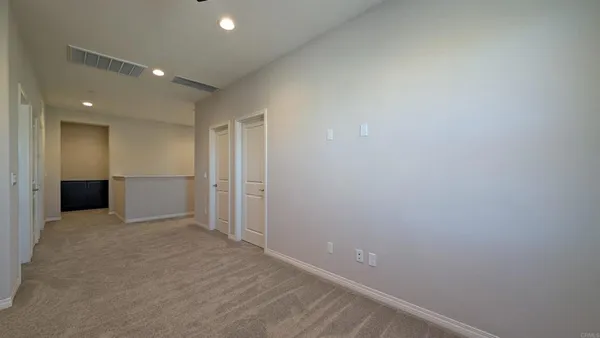 an empty room with windows and closet