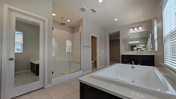 a bathroom with a sink vanity and a mirror