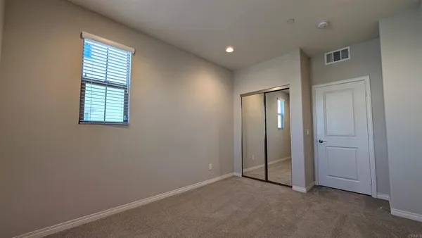 a bedroom with a bed and a television