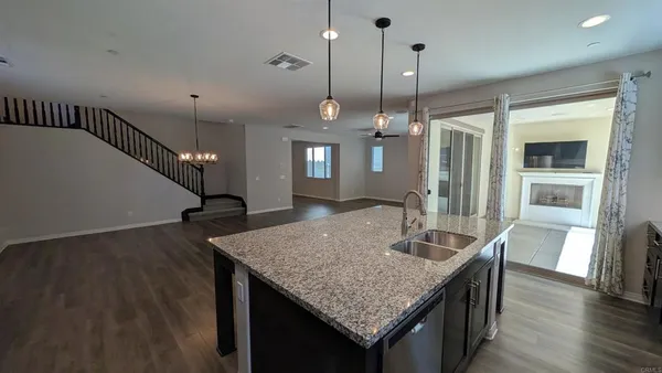 a kitchen with center island table and chairs