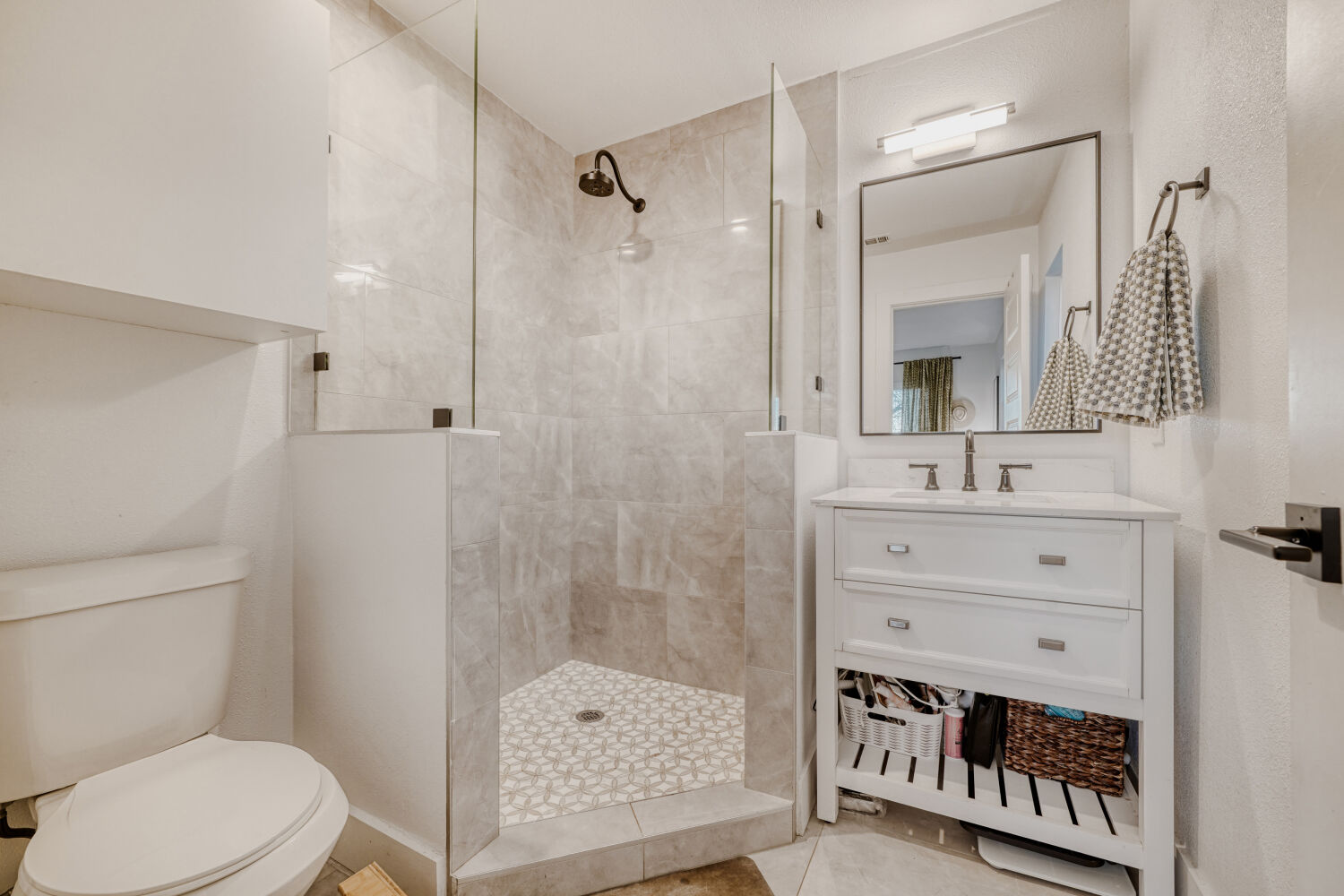 5313 Downs Drive Austin, TX 78721 - Photo 16 of 21 a bathroom with a sink a toilet a mirror and shower