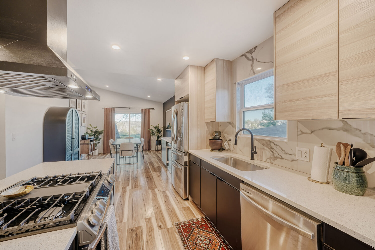 5313 Downs Drive Austin, TX 78721 - Photo 9 of 21 a kitchen with kitchen island a counter top space a sink stainless steel appliances and cabinets