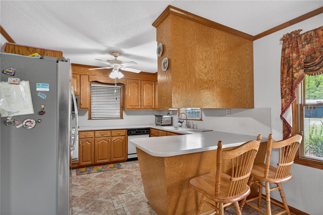 145 State Rd S-4-935 Pendleton, SC 29670 - Photo 7 of 47 A classic kitchen setup features ample oak cabinetry and a convenient breakfast bar.