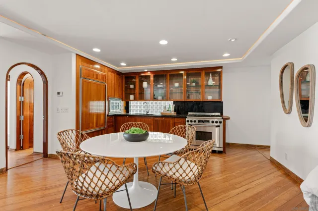 a living room with furniture and a large window with wooden floor