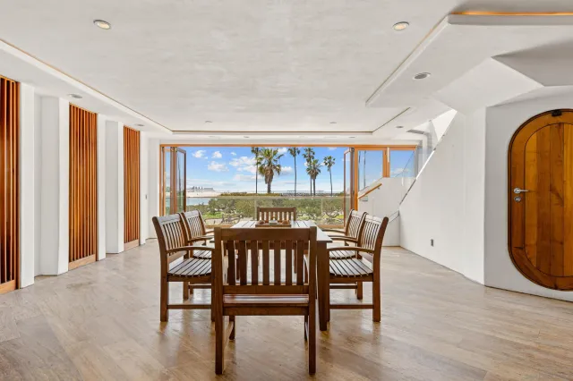 a view of a dining room with furniture wooden floor and chandelier