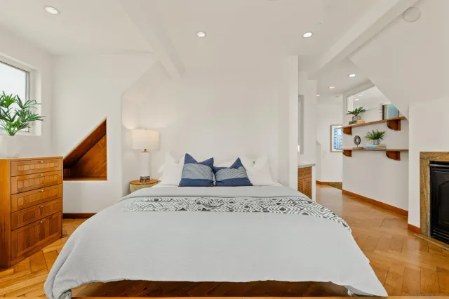 a spacious bedroom with a bed and glass door