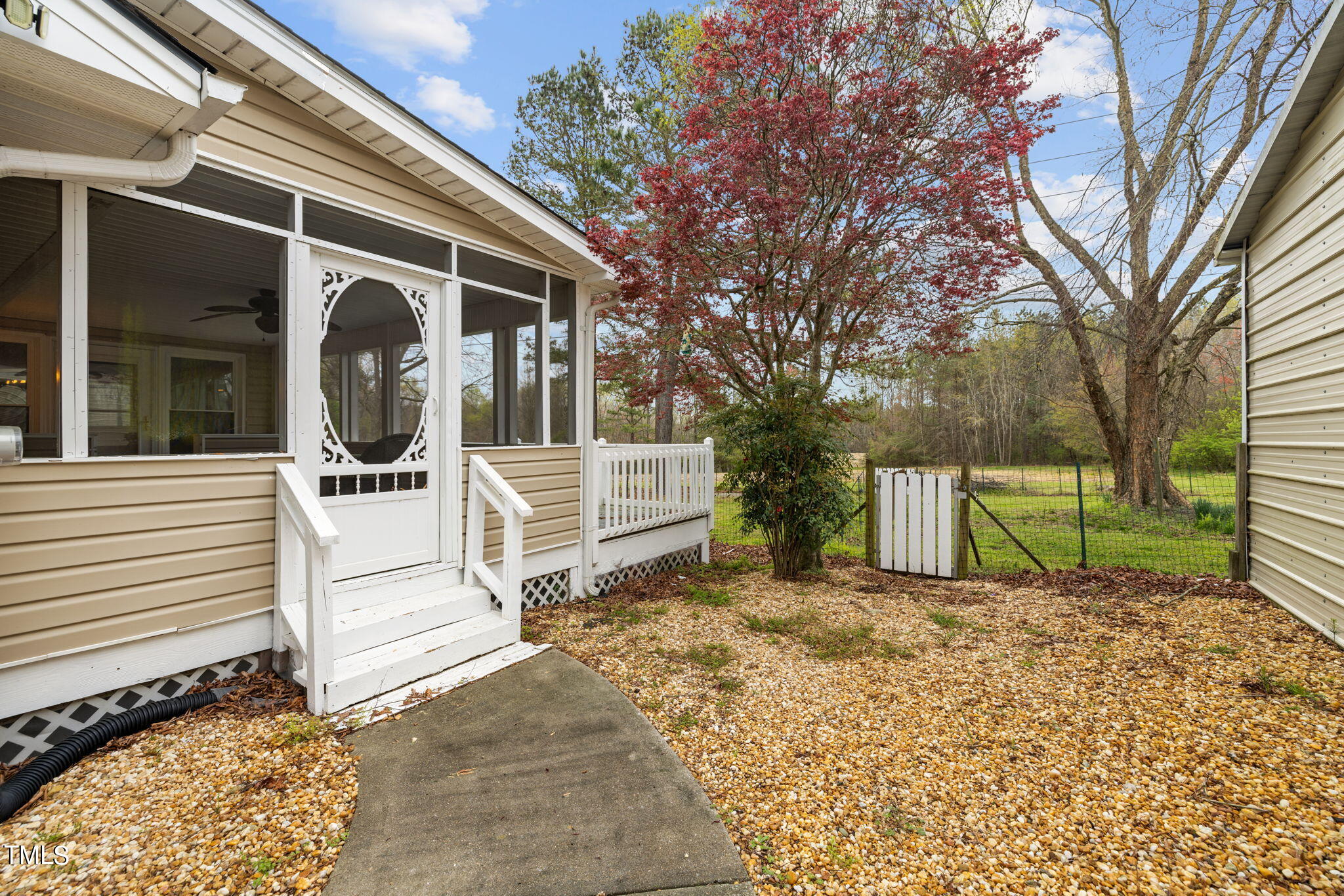 244 Ferrells Bridge Road Bunn, NC 27508 - Photo 12 of 36 a view of a house with a small yard and wooden fence