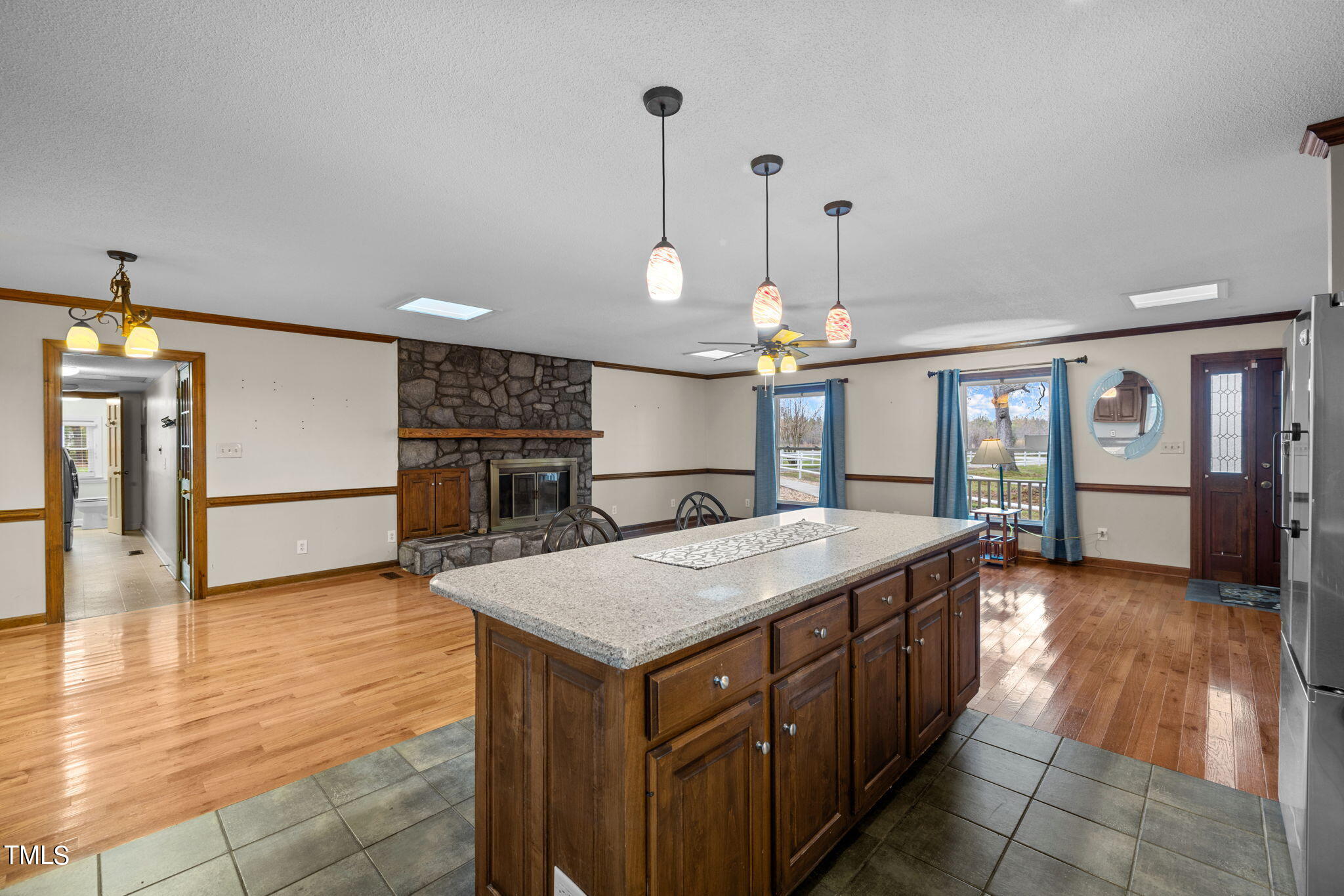 244 Ferrells Bridge Road Bunn, NC 27508 - Photo 6 of 36 a kitchen with kitchen island granite countertop a oven and a view of living room