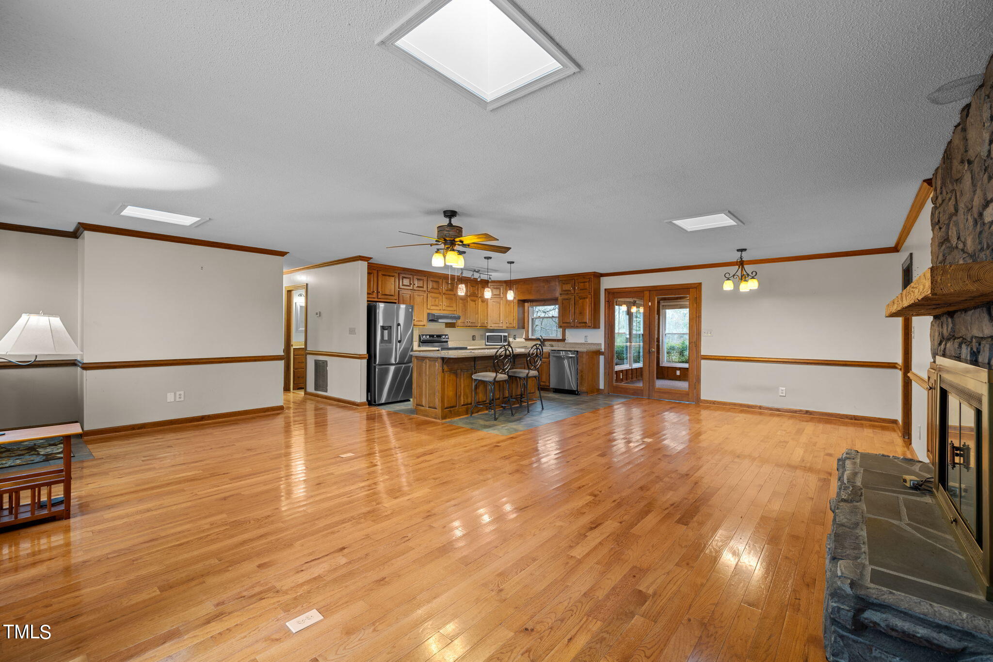 244 Ferrells Bridge Road Bunn, NC 27508 - Photo 7 of 36 a view of a living room with kitchen and a wooden floor