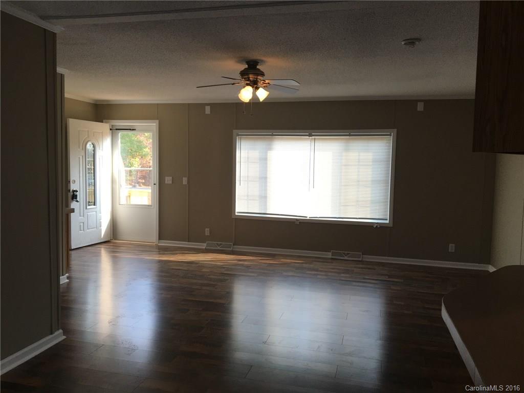 4860 Yoder Road Crouse, NC 28033 - Photo 16 of 20 a view of empty room with wooden floor and fan