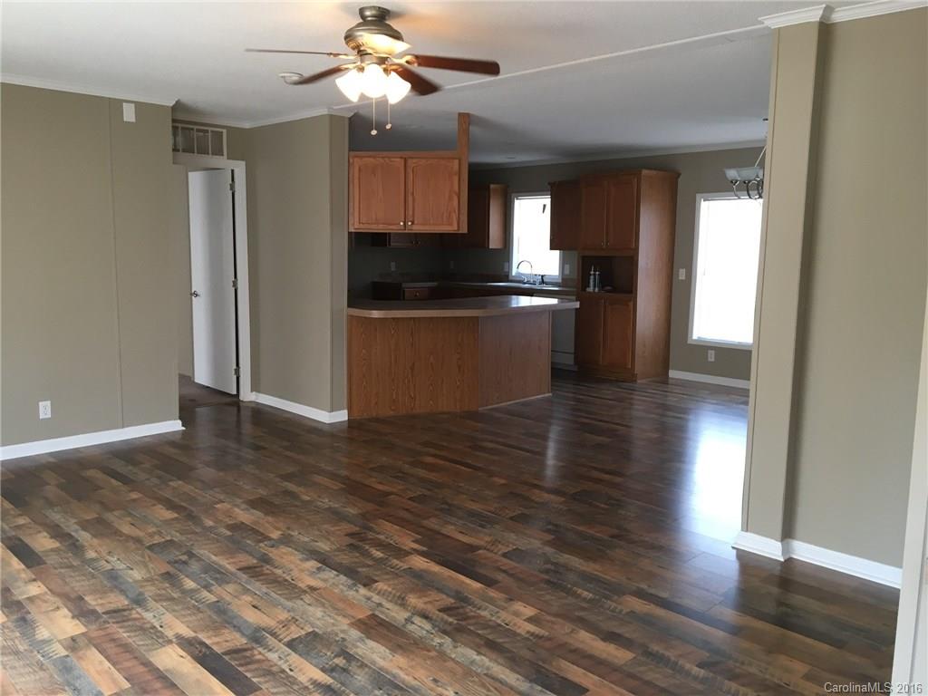 4860 Yoder Road Crouse, NC 28033 - Photo 5 of 20 a view of a kitchen with a sink and dishwasher a refrigerator with wooden floor