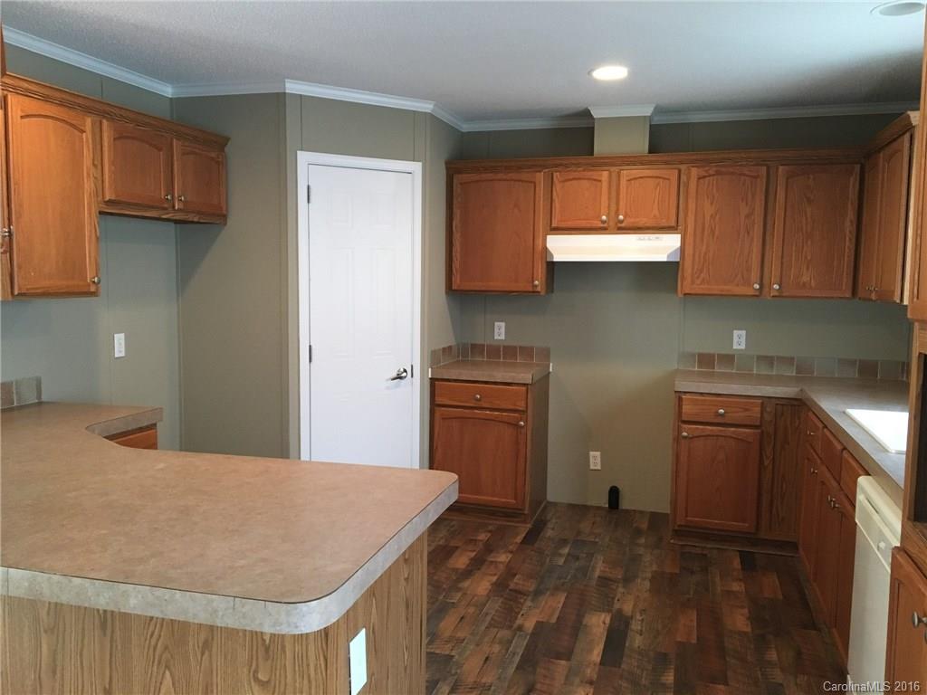 4860 Yoder Road Crouse, NC 28033 - Photo 6 of 20 a kitchen with kitchen island sink stove and cabinets
